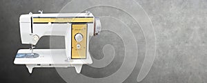 Front view old white and yellow sewing machine on cement background,object,copy space
