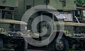 Front view of old wrecked military green truck wil old flat tyre. Abandoned rusty military truck. Decayed abandoned truck with US