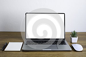 Front view of open laptop computer notebook with blank monitor white screen display on work table desk.