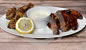 Front View of plated Lemon Pepper and Honey BBQ Chicken Wings