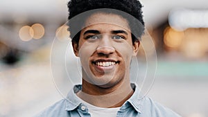 Front view portrait male face close-up african millennial man guy looking at camera smiling waving nods head answering