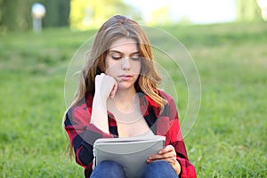 Student studying memorizing notes on the grass photo