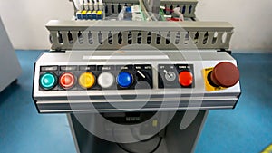 Front view of the push button on the industrial control panel.