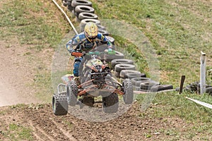 Front view of quad rider jumping in the race