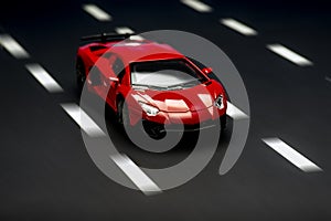 Front view of a red sports car on an asphalt background with road lanes