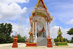 Front view of the red and white temple with the guards and steps leading to the main idol inside at Buang Sam Phan, Phetchabun photo