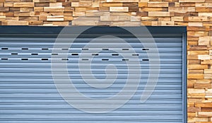 Front view of roller shutter door on timber wall background