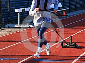 Front view of a runner pulling a sled with weight on top