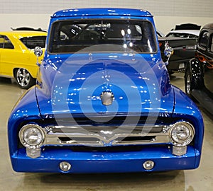 Front view of a 1940's model Blue Ford pick-up truck.