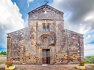 Front view of Santa Maria del Regno cathedral in Ardara under a dramatic sky