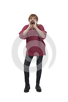 front view of a screaming woman with open mouth and raised arms looking at camera