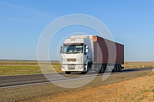 Front view of Semi-Truck with Cargo Trailer Driving on a Highway.