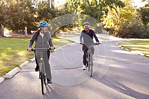 Front View Of Senior Couple Cycling Through Park Together