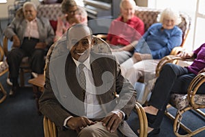 Front view of senior man looking at camera in nursing home