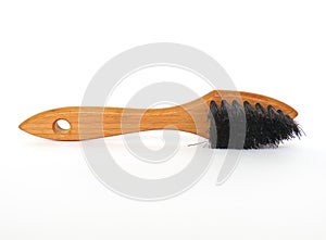 Front view of shoe cleaning brush isolated on white background. Light wood brush horizontal shoe shine applicator. Unique and