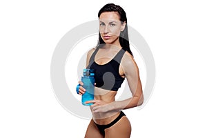 Front view of slim fitness woman drinking water.