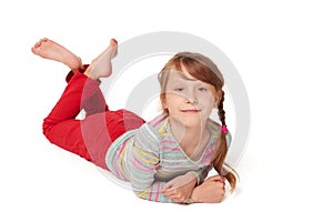 Front view of smiling child girl lying on floor