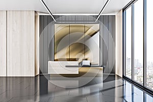 Front view on stylish on reception desk in sunlit spacious office area with golden and slatted wall, dark grey ceramic floor and