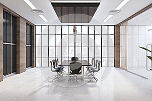 Front view on stylish sunny spacious meeting room interior with black conference table and chairs in the center, big lattice