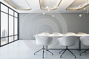 Front view on stylish white conference table surrounded by chairs in empty spacious meeting room with grey slatted wall background