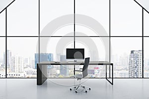 Front view on stylish workspace table with modern computer and dark office chair on light glossy floor on great city skyline view