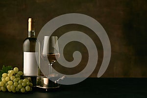 Front view of tasty fruit plate with the wine bottle on dark studio background