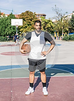 Front view of an urban basketball player on an outdoor court