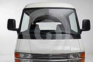 Front view of VAN, emphasizing the windshield, headlights, and front grille