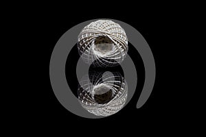 Front view of white ball of string on black background