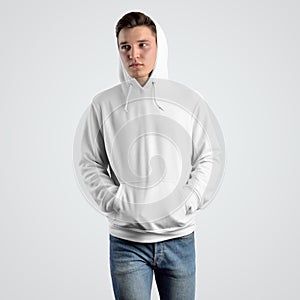 Front view of a white hoodie mockup on a young guy in a hood