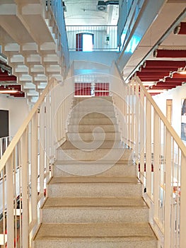 Front view of white staircase inside an office building. Architectural and construction details. Modern and industrial