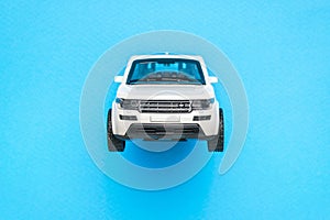 Front view of a white SUV on a blue background. The concept of auto mania