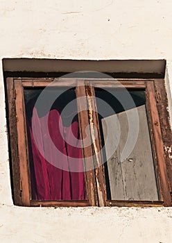 Front view of window, drape and shutter of vintage hotel in Spain