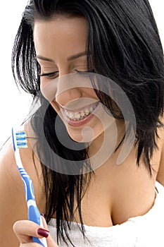 Front view of woman holding toothbrush