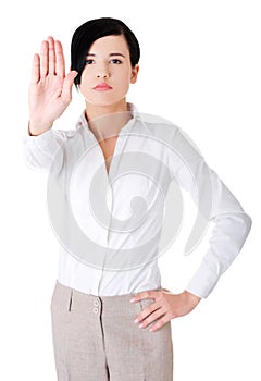 Front view of a woman showing stop sign