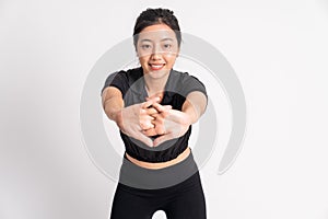 front view of woman wearing black sportswear stretching hands