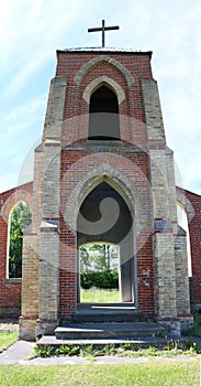 Front wall of vintage church left standing as memorial to parish