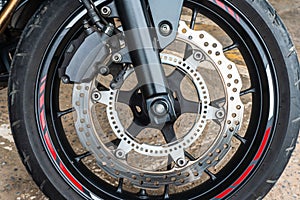 Front wheel close up of brakes system in a modern motorcycle modern