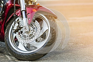 Front wheel of sports motorcycle on road. Motorbike parked on a