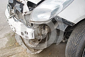 Front of white car damaged automobiles after collision on the road