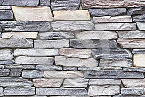 Front wide shot of highlighted masonry rectangle colorful stone wall in Izmir at Turkey with traditional stucco