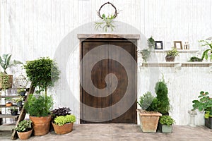 Front wood door and garden decor in white cosy house or cottage.