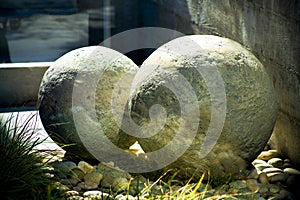 Front yard boulders with natural stones and hidden grass in art instilation or decorative yard design for modern home in