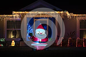 Front yard with brightly illuminated christmas decorations. Outside decor of florida family home for winter holidays
