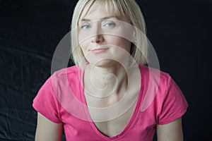 Frontal headshot portrait of mature woman wearing fuchsia shirt