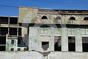 A frontal view of deserted foundry windows zoomed