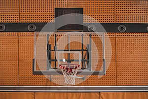 Frontal view of a net on a baksketball table viewed from under the basket in a gym or stadium