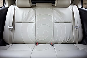 Frontal view of opulent white leather back passenger seats in a sophisticated modern luxury car