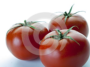FROntal view of three red tomatoes 2 photo