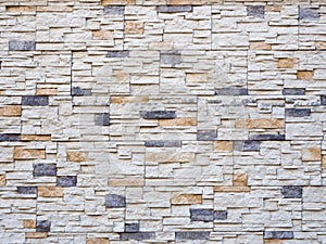 Frontal view of a wall with decorative masonry. Background texture. Full screen